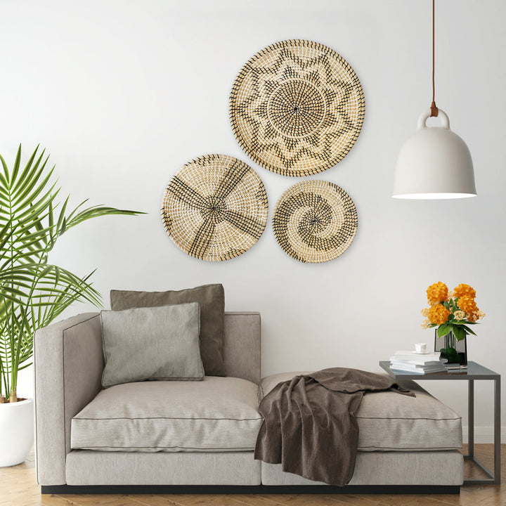 Set of 3 round woven baskets with symmetrical radiating patterns in beige and dark brown by Artera Home