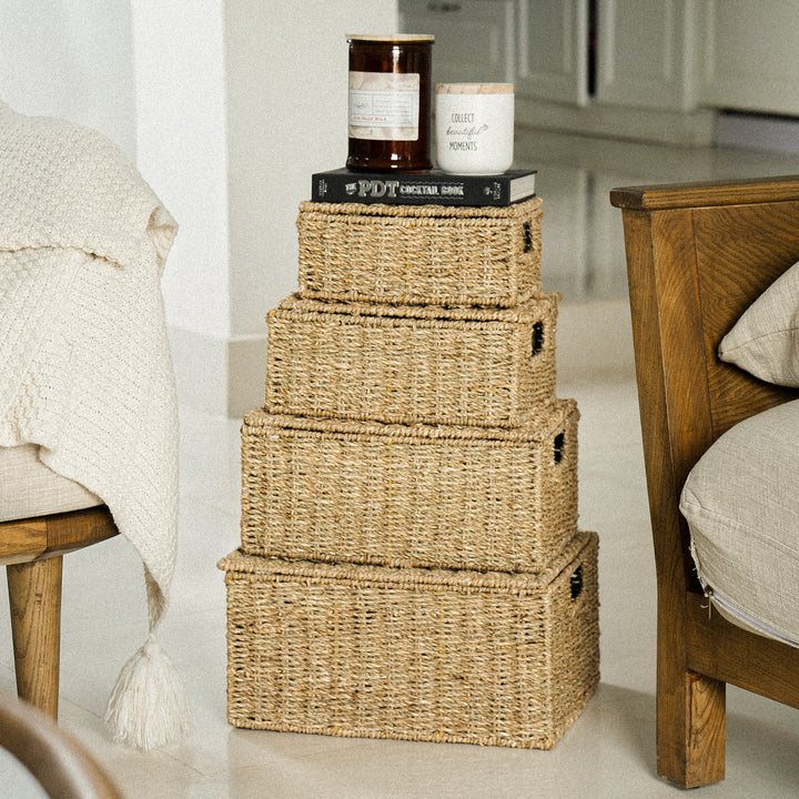 4-woven-storage-basket-stacked-neatly-in-a-living-room-topped-with-candles-and-books