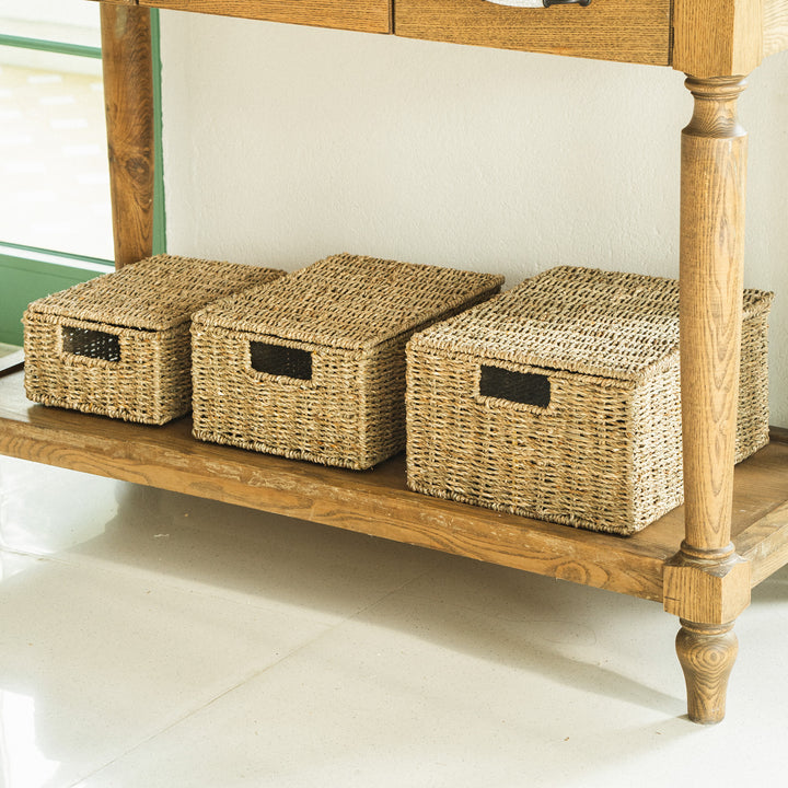 3-rectangular-seagrass-woven-baskets-placed-under-a-wooden-console-table