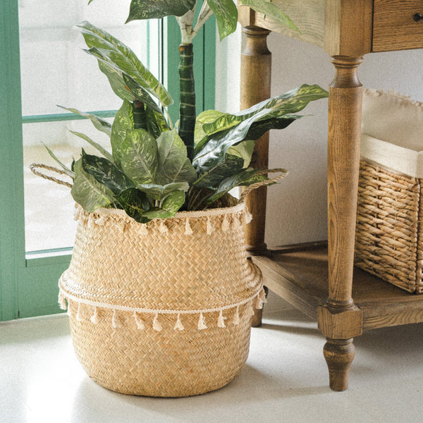 A-natural-seagrass-wicker-planter-with-a-tasseled-design-adds-a-charming-touch-to-your-indoor-greenery