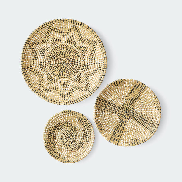 Set of 3 round woven baskets with symmetrical radiating patterns in beige and dark brown by Artera Home