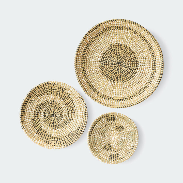 Set of 3 round woven baskets with natural and dark brown concentric circular patterns by Artera Home