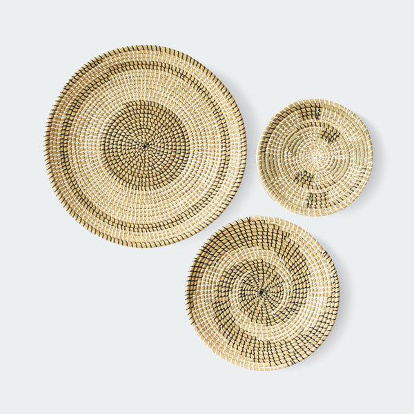 Set of 3 round woven baskets with natural and dark brown concentric circular patterns by Artera Home