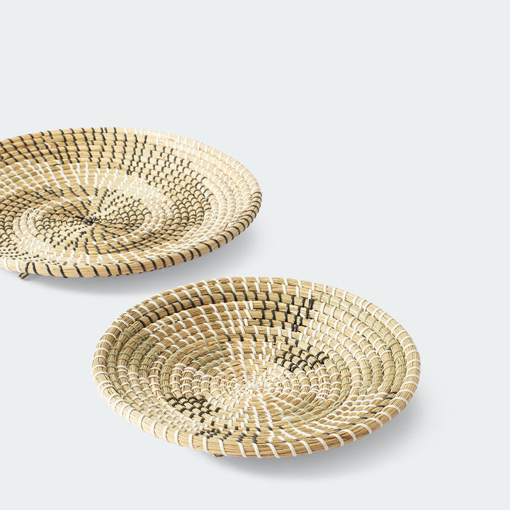 Set of 3 round woven baskets with natural and dark brown concentric circular patterns by Artera Home