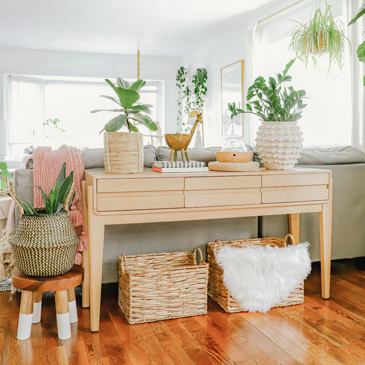 Artera Home large water hyacinth wicker basket placed under a table in the living room