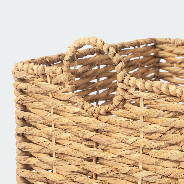 A close-up look at the weaving handle of a large rectangle of water hyacinth wicker basket