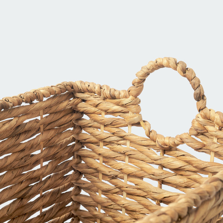 A close-up look at the weaving handle of a large rectangle of water hyacinth wicker basket