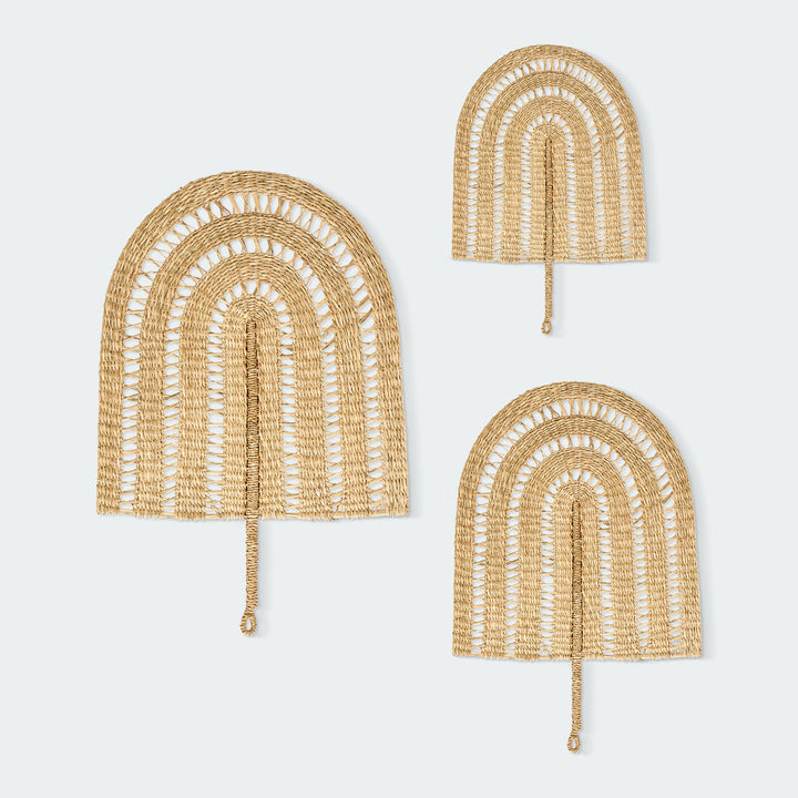A set of three woven wall fans in various sizes, hanging on wall, by Vietnamese artisans from Artera Home