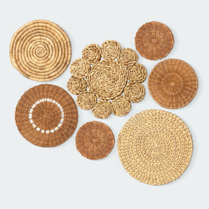 A set of 7 circular wall baskets made of rattan, water hyacinth, and floral patterns by Vietnamese artisans from Artera Home