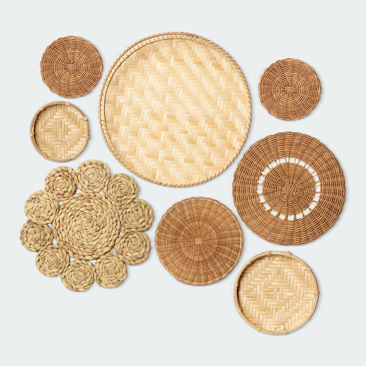 A set of 8 circular wall baskets made of natural materials by Vietnamese artisans from Artera Home, with a focus on the different textures and sizes of the baskets.