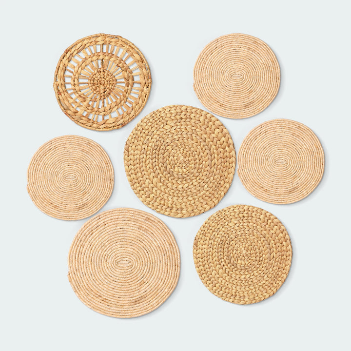 A set of 7 circular wall baskets made of natural materials by Vietnamese artisans from Artera Home