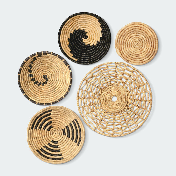 A set of 5 circular wall baskets made of natural materials by Vietnamese artisans from Artera Home