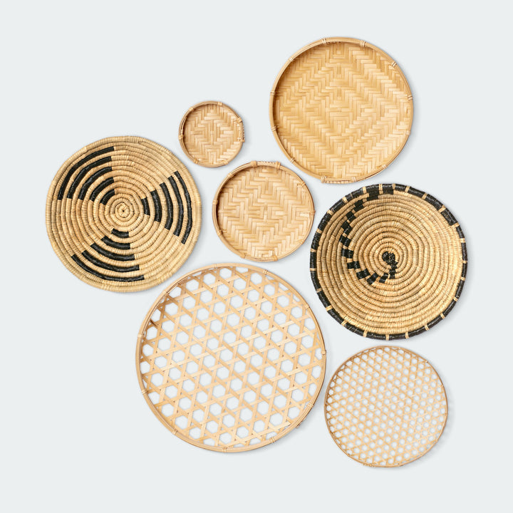 A set of 7 circular wall baskets made of organic bamboo and seagrass by Vietnamese artisans from Artera Home