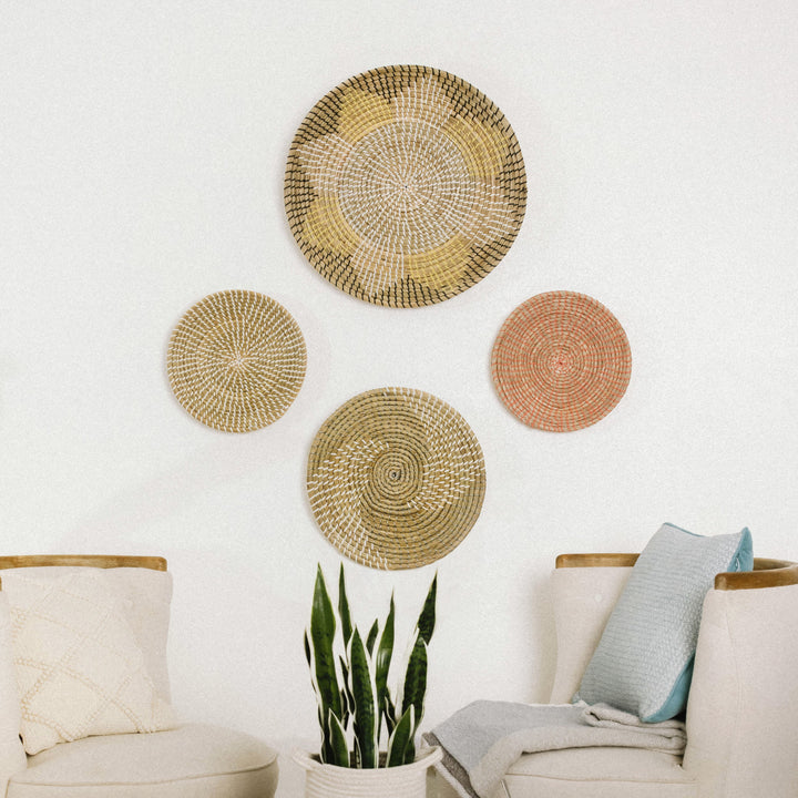 A cozy seating area with a wooden bench adorned with checkered pillows, with four decorative wall basket decor