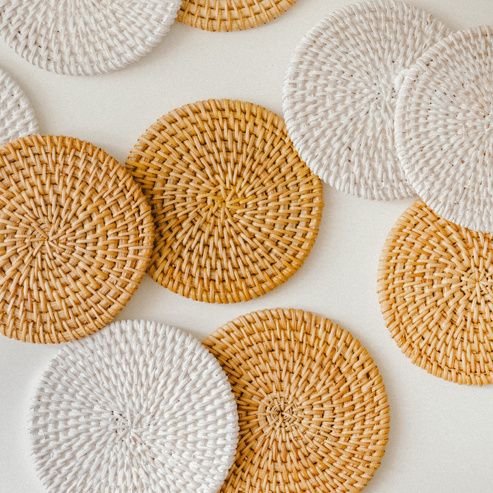 An-array-of-woven-coaster-set-in-brown-and-white-colors-arranged-in-a-scattered-pattern