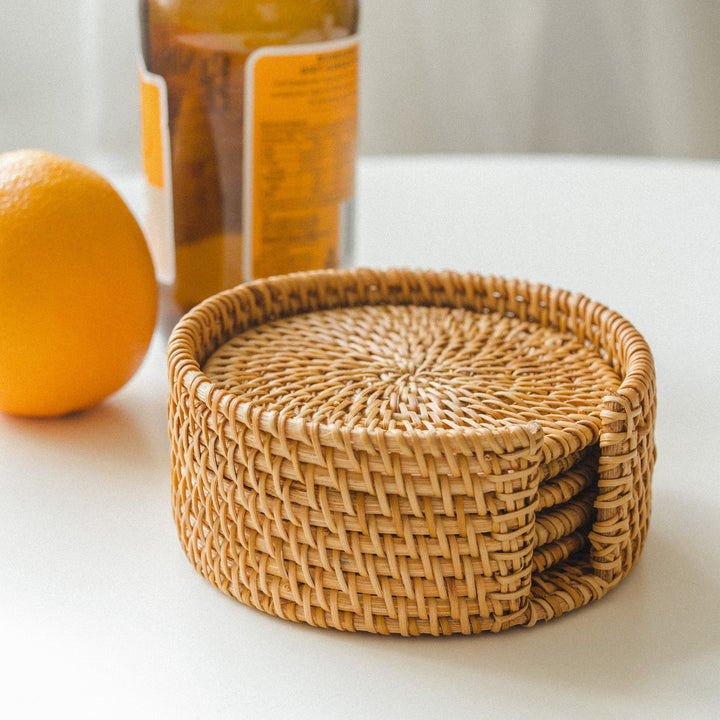 A-stack-of-honey-brown-rattan-coasters-neatly-organized-in-a-round-holder