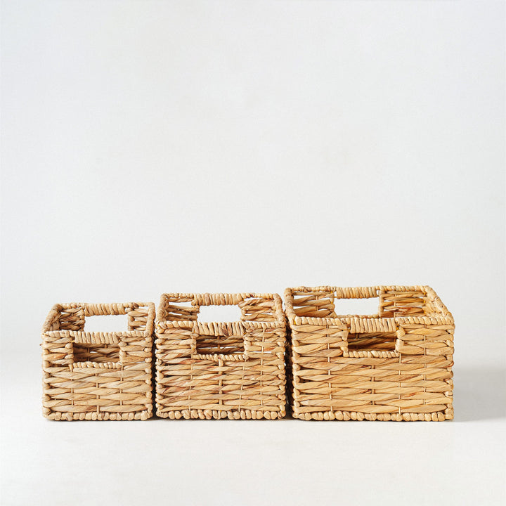 A close-up look of a rectangular twisted water hyacinth wicker storage basket filled with books