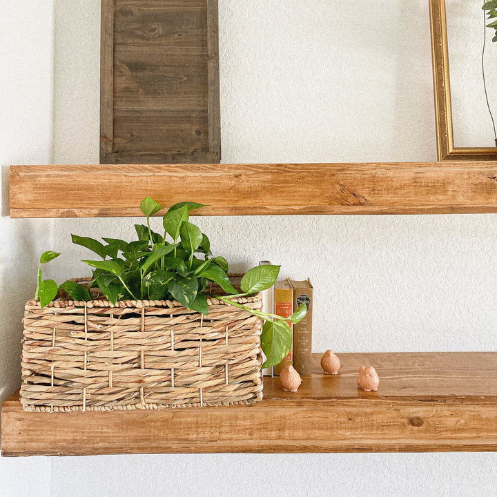 A close-up right corner of a water hyacinth wicker storage basket with built-in handles