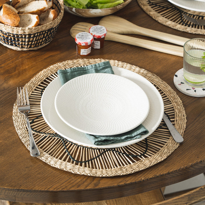 Set of 6 round wicker placemats with black sun-like thread design