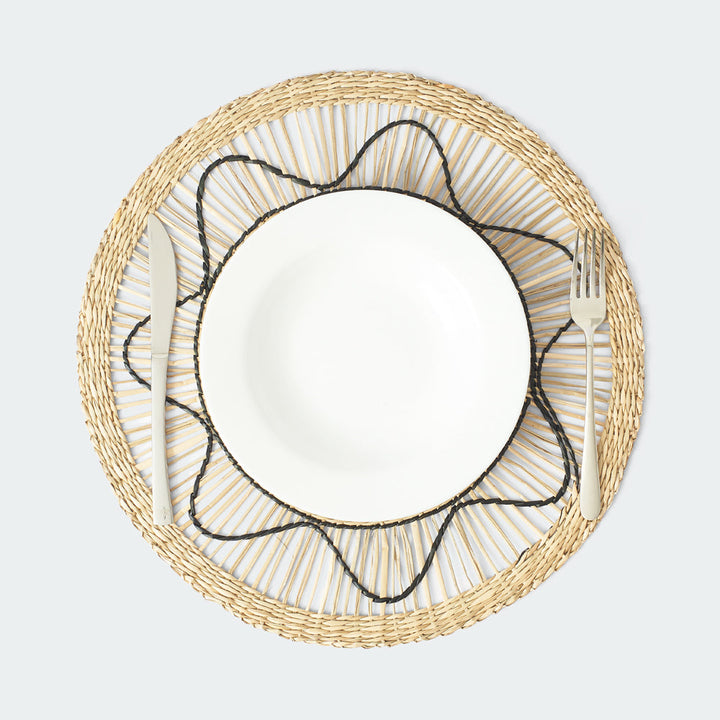 Set of 6 round wicker placemats with black sun-like thread design