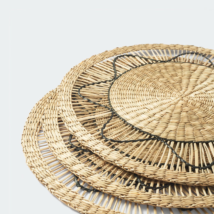 Set of 6 round wicker placemats with black sun-like thread design