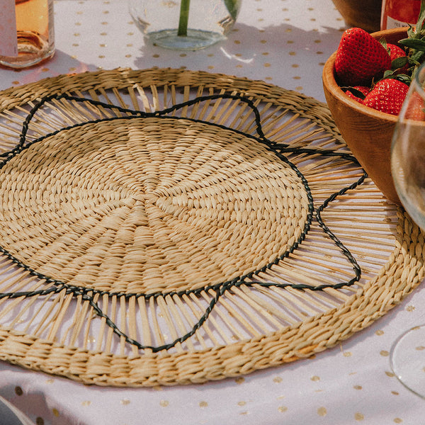 Set of 6 round wicker placemats with black sun-like thread design