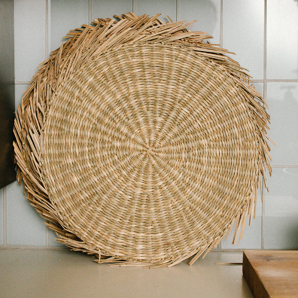 Round sunburst seagrass woven placemat set of 6 on the kitchen countertop