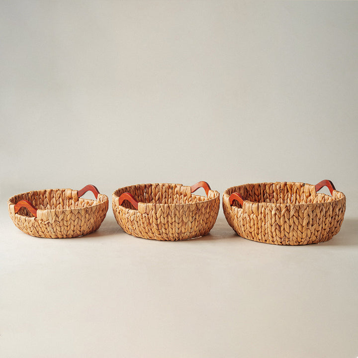 Round water hyacinth wicker storage basket set of 3 placed in a straight line